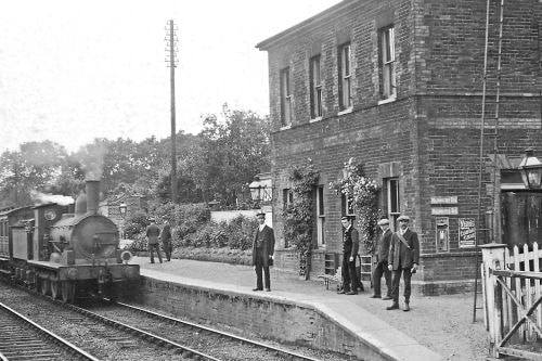 Brundall Station, c 1915.  A goods train - T26 class No. 490 - is met by stationmaster William Miles and staff.