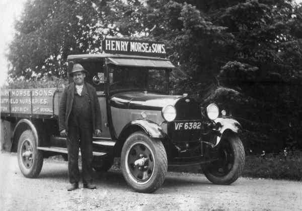 A driver for Henry Morse stands proudly next to a delivery 
truck--it is a Ford Model AA truck, circa 1930