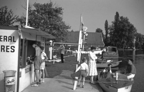 The Riverside Stores, situated at Tidecraft Cruisers, provided a welcome respite
for parents and were a magnet for children on this hot summer day on the Broads in 1959.
Sadly this shop, the only one on the riverside, closed several years ago.